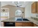 Kitchen features a sink with granite countertops and a view of the backyard at 533 N Cobblestone St, Gilbert, AZ 85234