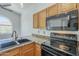 Kitchen features granite countertops, stainless appliances, sink with gooseneck faucet, and wooden cabinets at 533 N Cobblestone St, Gilbert, AZ 85234
