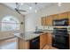 Kitchen features granite countertops, ample cabinet space, and black appliances at 533 N Cobblestone St, Gilbert, AZ 85234