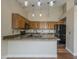 Well-lit kitchen with pendant lighting, granite countertops, and oak cabinets at 533 N Cobblestone St, Gilbert, AZ 85234