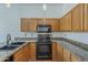 Kitchen area featuring granite countertops, cabinets, and appliances at 533 N Cobblestone St, Gilbert, AZ 85234