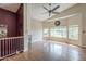 Open-concept living room with fireplace, hardwood floors, and abundant natural light at 533 N Cobblestone St, Gilbert, AZ 85234