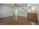 Spacious living room with hardwood floors, a ceiling fan and a staircase leading to the second floor at 533 N Cobblestone St, Gilbert, AZ 85234