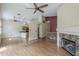 Large open living room with fireplace, kitchen access, and multiple ceiling fans at 533 N Cobblestone St, Gilbert, AZ 85234