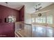 Bright living room with vaulted ceilings, ceiling fan, and large windows at 533 N Cobblestone St, Gilbert, AZ 85234