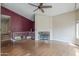 Spacious living room with a cozy fireplace and staircase with white railing at 533 N Cobblestone St, Gilbert, AZ 85234