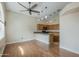Open living area with hardwood floors, pendant lights, and kitchen access at 533 N Cobblestone St, Gilbert, AZ 85234