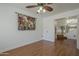 Bright room with hardwood floors and a ceiling fan, open to the staircase at 533 N Cobblestone St, Gilbert, AZ 85234
