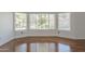 Cozy living room featuring hardwood floors and a bay window providing natural light and great views at 533 N Cobblestone St, Gilbert, AZ 85234