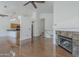 Spacious living room with hardwood floors, modern fireplace, and open layout to the kitchen area at 533 N Cobblestone St, Gilbert, AZ 85234