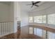 Bright living room featuring hardwood floors, a fireplace and large windows that provide natural light at 533 N Cobblestone St, Gilbert, AZ 85234