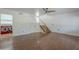 Bright living room featuring hardwood floors, a ceiling fan, and a view into the laundry room at 533 N Cobblestone St, Gilbert, AZ 85234