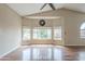 Bright living room featuring hardwood floors, large windows, and a vaulted ceiling at 533 N Cobblestone St, Gilbert, AZ 85234