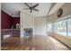 Spacious living room with fireplace, hardwood floors, and large windows at 533 N Cobblestone St, Gilbert, AZ 85234