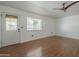 Clean room with hardwood floors, a ceiling fan, and a door leading outside at 533 N Cobblestone St, Gilbert, AZ 85234