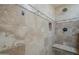 Neutral-tiled shower with built-in bench and shower head at 533 N Cobblestone St, Gilbert, AZ 85234