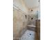 Shower featuring beautiful travertine tile and a built-in bench at 533 N Cobblestone St, Gilbert, AZ 85234