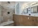 Shower and bathroom with neutral colored tile and updated lighting at 533 N Cobblestone St, Gilbert, AZ 85234