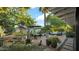 Serene backyard with brick patio, outdoor seating, dining area, lush greenery, and mature trees at 5714 N 11Th St, Phoenix, AZ 85014