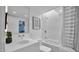 Bright, updated bathroom with large mirror, vanity, integrated sink, and shower/tub combo with skylight at 5714 N 11Th St, Phoenix, AZ 85014