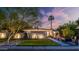 Inviting single-story home with lush front lawn and xeriscaping under a dramatic dusk sky at 5714 N 11Th St, Phoenix, AZ 85014