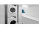 Functional laundry room with stacked washer and dryer and bright white cabinets at 5714 N 11Th St, Phoenix, AZ 85014