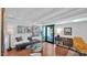 Comfortable living room boasts art, beams, and glass doors for outdoor access at 5714 N 11Th St, Phoenix, AZ 85014