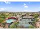 Stunning aerial view of a community pool, tennis courts, golf course and parking in a beautiful residential area at 6145 E Snowdon St, Mesa, AZ 85215