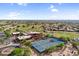 Picturesque desert community featuring lush green golf course, tennis courts, and stunning mountain backdrop at 6145 E Snowdon St, Mesa, AZ 85215