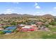Panoramic aerial view showcasing the community's golf course, tennis courts, and desert landscape at 6145 E Snowdon St, Mesa, AZ 85215