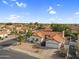 A desirable home boasts a red tile roof, meticulously maintained desert landscaping, and an attached two-car garage at 6145 E Snowdon St, Mesa, AZ 85215