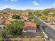 Located in a scenic setting, this home features desert landscaping, a red tile roof, and mountain views at 6145 E Snowdon St, Mesa, AZ 85215