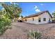 This backyard features desert landscaping, a neutral color scheme, and a patio with a barbecue at 6145 E Snowdon St, Mesa, AZ 85215