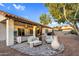 Backyard patio featuring comfortable furniture, desert landscaping, and a covered area with string lights at 6145 E Snowdon St, Mesa, AZ 85215