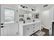 Bathroom features a double vanity, modern lighting, and a large mirror at 6145 E Snowdon St, Mesa, AZ 85215