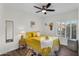 Bright bedroom with hardwood floors, a ceiling fan, and natural light from the shuttered window at 6145 E Snowdon St, Mesa, AZ 85215