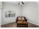 Bedroom area features a cozy sofa, shuttered window, and neutral color palette at 6145 E Snowdon St, Mesa, AZ 85215