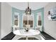 Cozy breakfast nook with a bay window, bench seating, and a modern light fixture at 6145 E Snowdon St, Mesa, AZ 85215