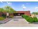 Inviting building entrance featuring lush green bushes and mature trees, enhancing the property's curb appeal at 6145 E Snowdon St, Mesa, AZ 85215