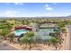 Community aerial view with tennis courts, a pool, lush green landscape, and desert scenery at 6145 E Snowdon St, Mesa, AZ 85215