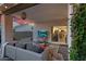 Stylish covered patio with comfortable seating, an outdoor TV, and views of the sunset at 6145 E Snowdon St, Mesa, AZ 85215