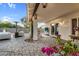 Relaxing covered patio with outdoor seating, string lights, and lush flowers at 6145 E Snowdon St, Mesa, AZ 85215