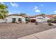 Classic single-Gathering home with a clean, well-kept exterior and spacious driveway under a blue sky at 6145 E Snowdon St, Mesa, AZ 85215