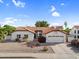 Charming single-story home with well-maintained landscaping, red tile roof, and attached two car garage at 6145 E Snowdon St, Mesa, AZ 85215