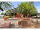 Community building with shade structure, desert landscaping, and stone walkways at 6145 E Snowdon St, Mesa, AZ 85215