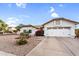 Charming single-story home features a two-car garage, gravel landscaping, and a new roof at 6145 E Snowdon St, Mesa, AZ 85215