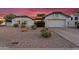 Charming single-story home features a two-car garage, gravel landscaping, and a new roof at 6145 E Snowdon St, Mesa, AZ 85215