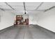 Spacious two-car garage with clean flooring, storage shelving, and an automatic door at 6145 E Snowdon St, Mesa, AZ 85215