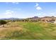 Scenic aerial shot of a meticulously maintained golf course surrounded by upscale residences and desert landscape at 6145 E Snowdon St, Mesa, AZ 85215