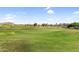 Expansive golf course view with lush green fairway and distant mountain views at 6145 E Snowdon St, Mesa, AZ 85215
